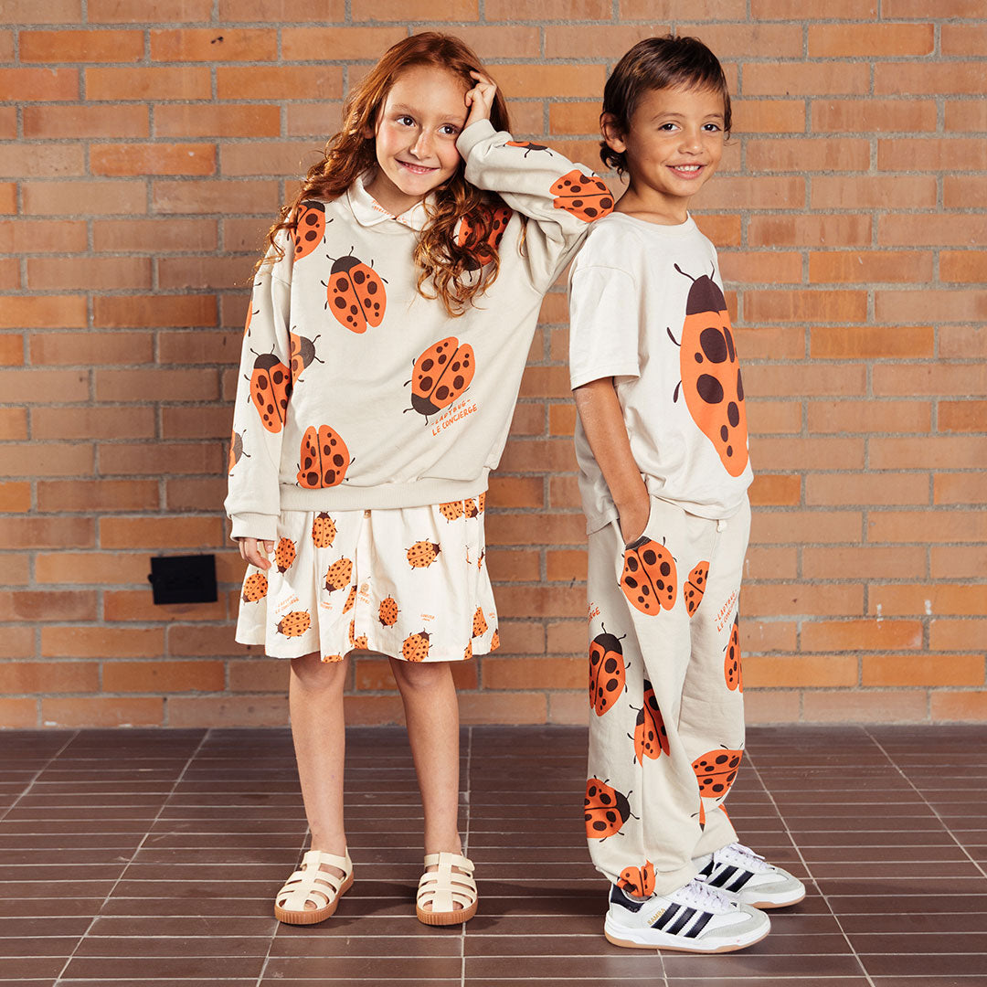 Pantalón infantil beige con mariquitas Ladybug, tipo sudadera infantil para niños y niñas, con cintura elástica y ajustable con cordón y bolsillos laterales, estampado completo de mariquitas - LOBSTER mini